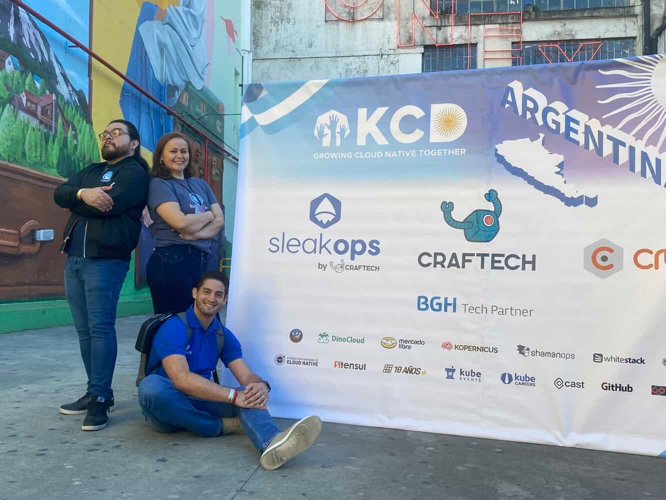 Participants taking picture in front of KCD Argentina banner