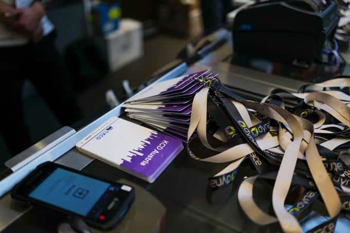 KCD Australia badge  on a table and a device to scan barcode